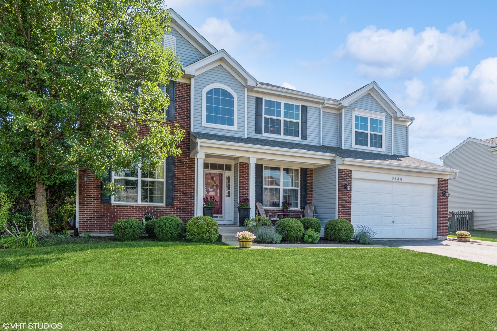 a front view of a house with a yard and garage