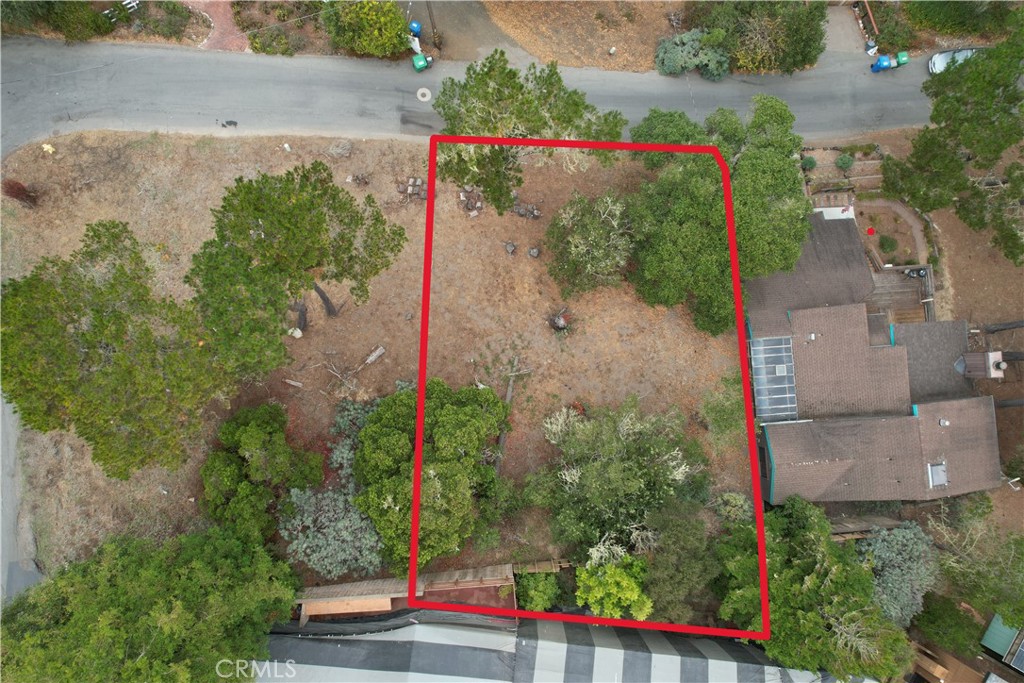 an aerial view of a houses with yard