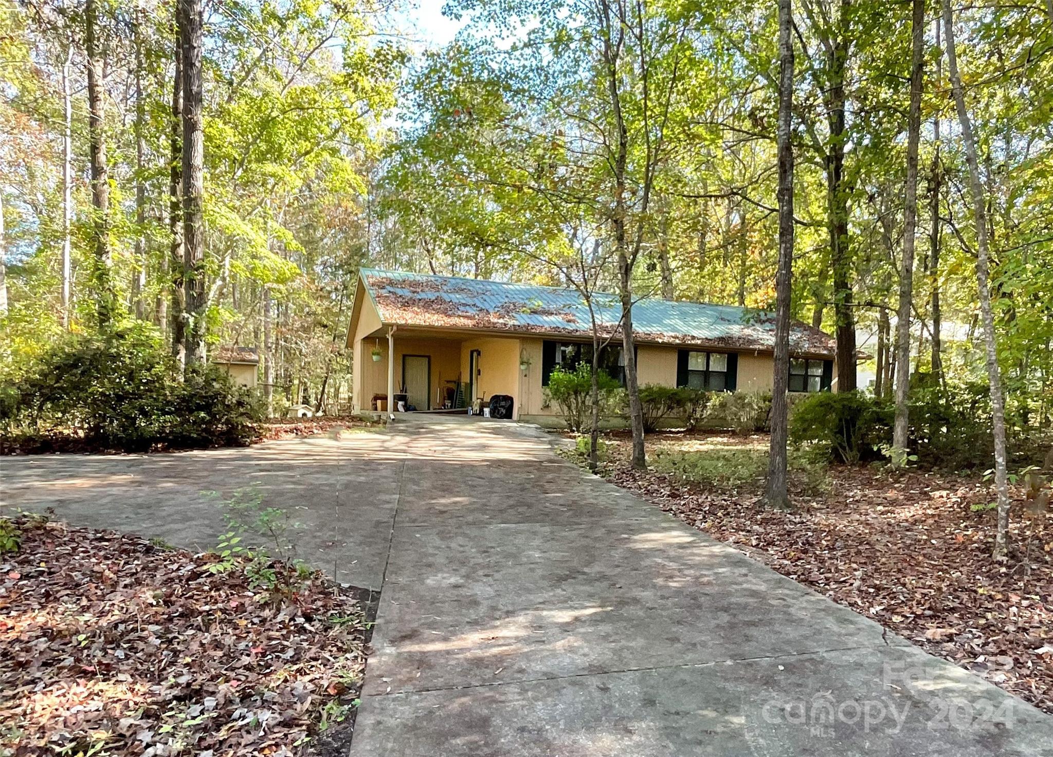 a view of a house with a yard and tree s