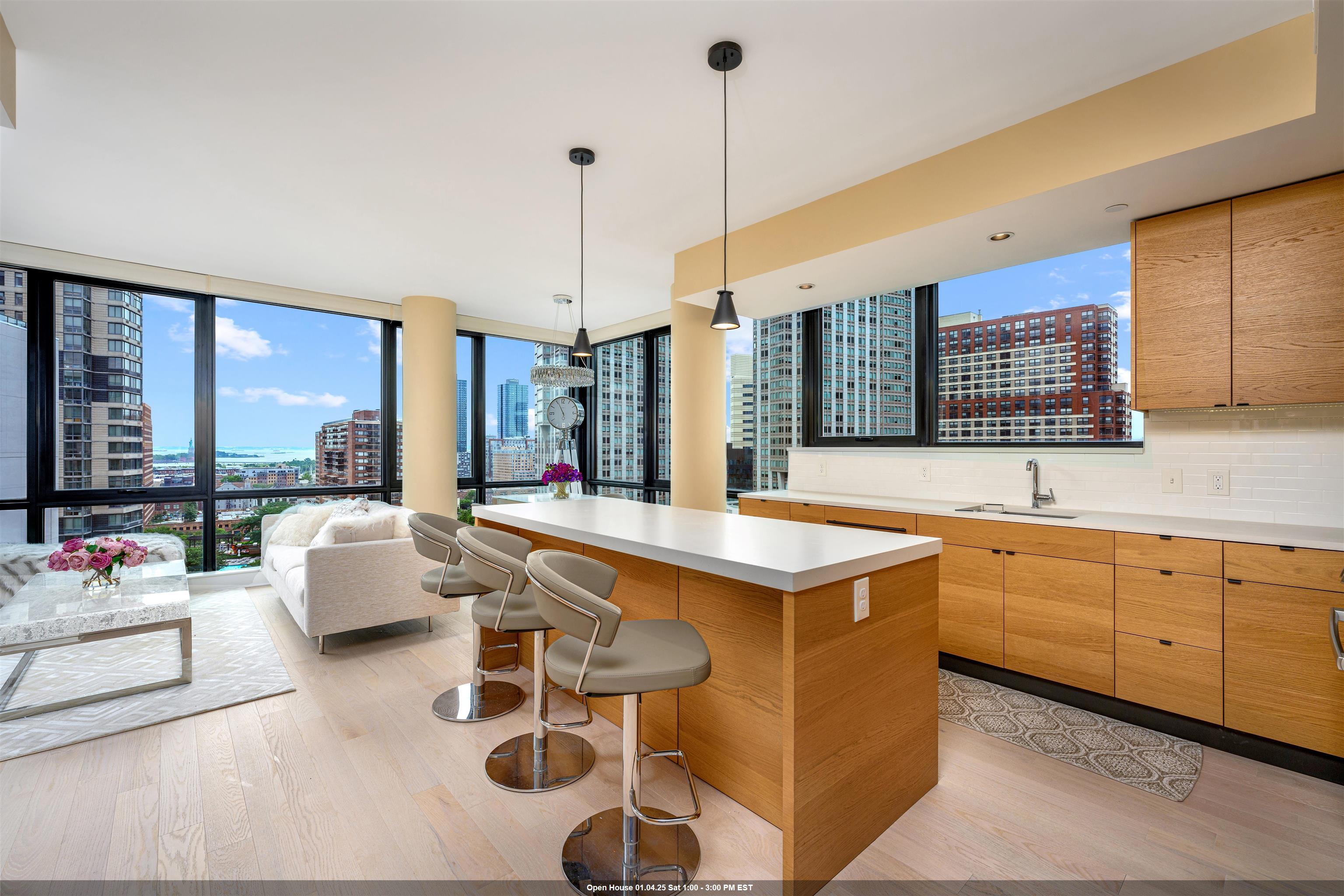 a kitchen with counter top space and living room view