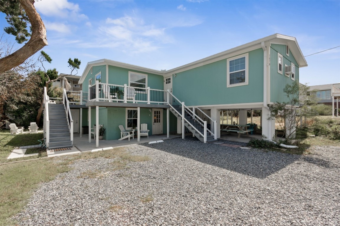 a view of a house with backyard porch and sitting area