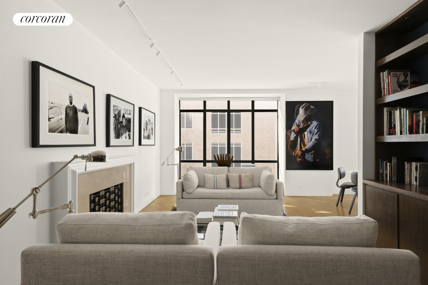 a living room with furniture and a book shelf