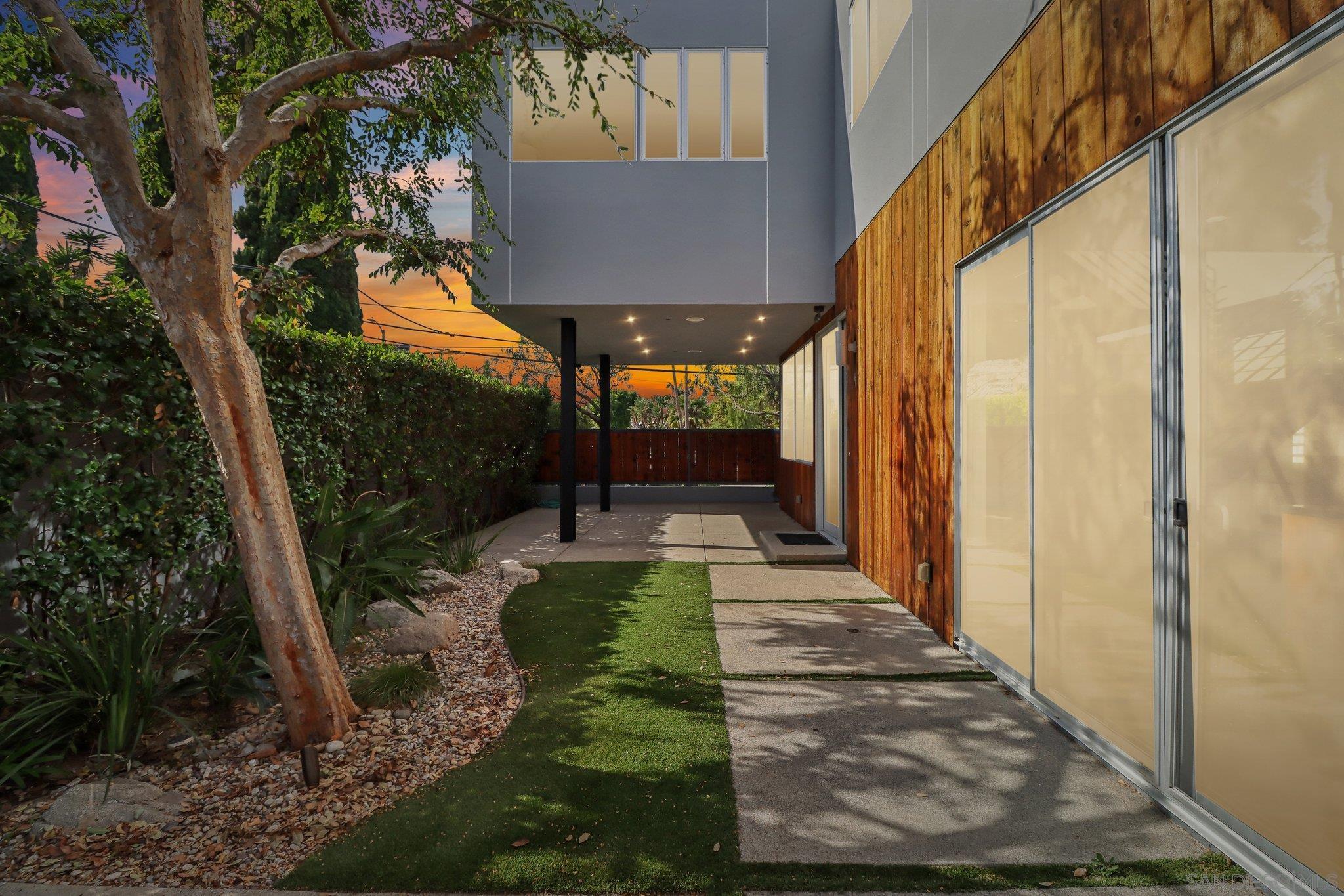 a view of a back yard with a wooden fence