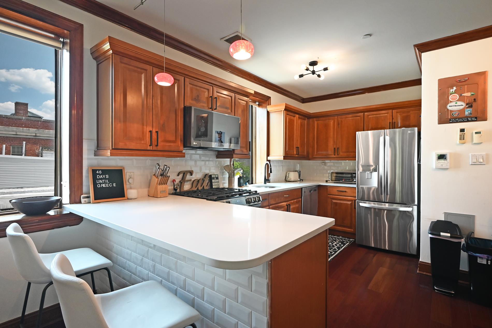 a kitchen with stainless steel appliances a stove refrigerator sink microwave and cabinets