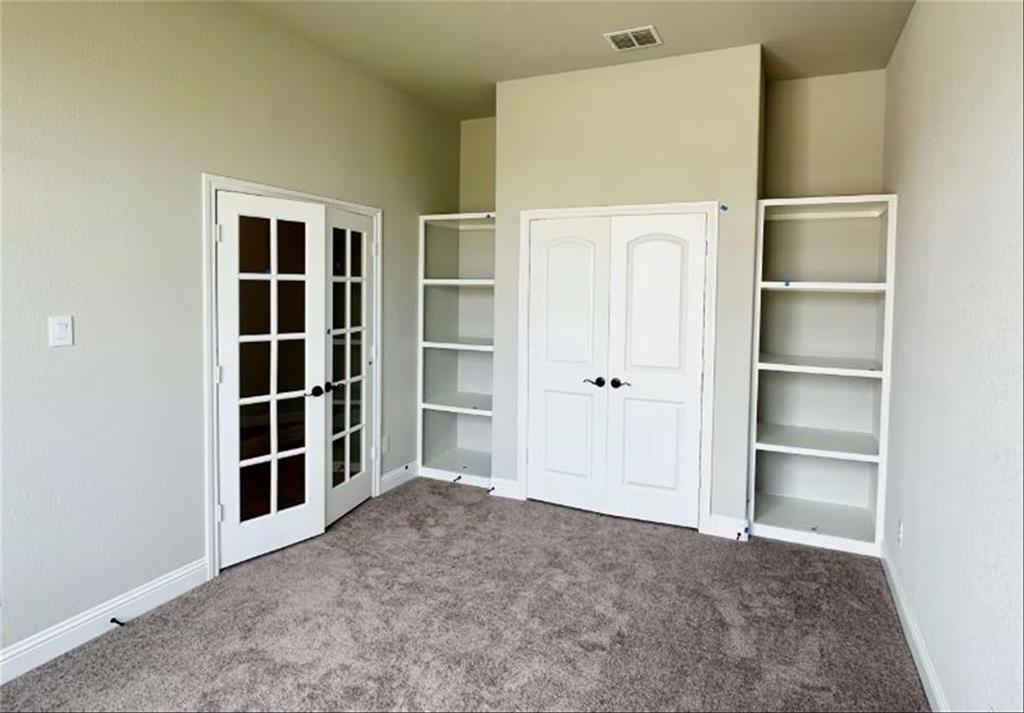 a view of an empty room with empty shelves