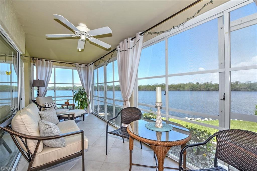 Sunroom featuring a water view and ceiling fan