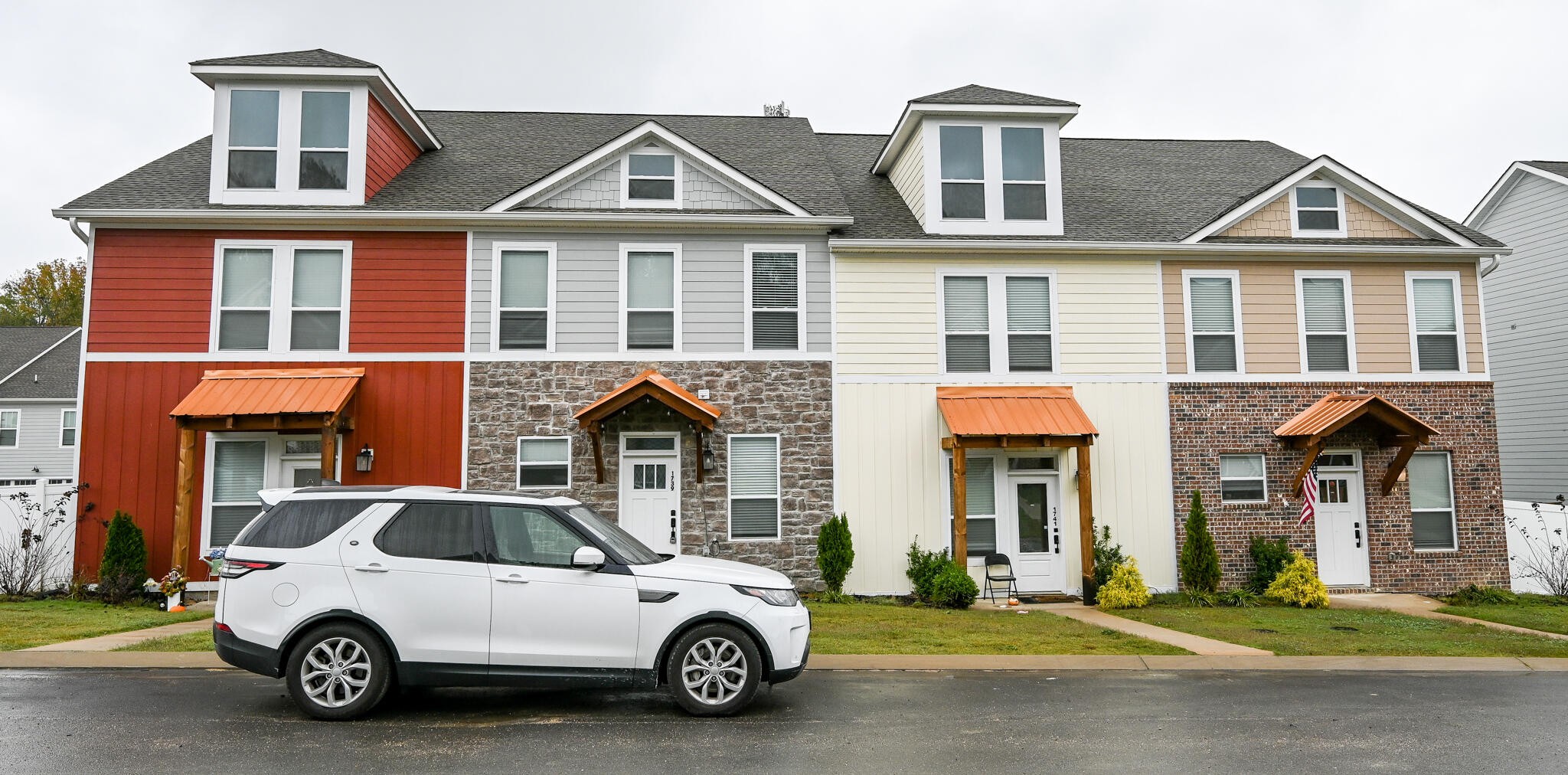 a car parked in front of a brick house