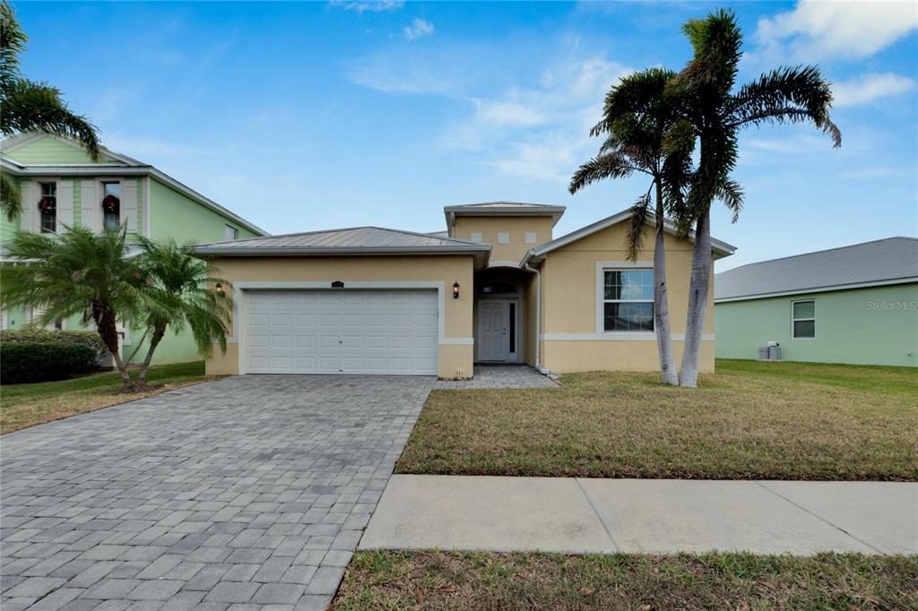 a front view of a house with a yard and garage