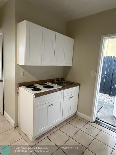 a kitchen with a stove and cabinets