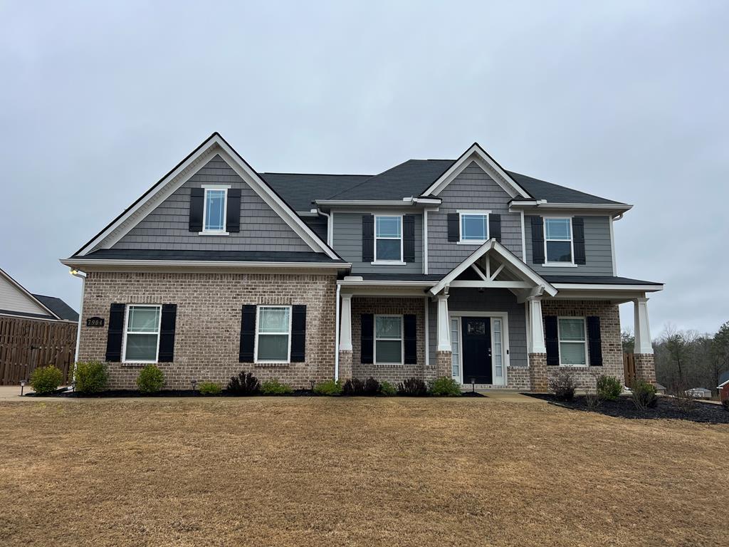 a front view of a house with yard