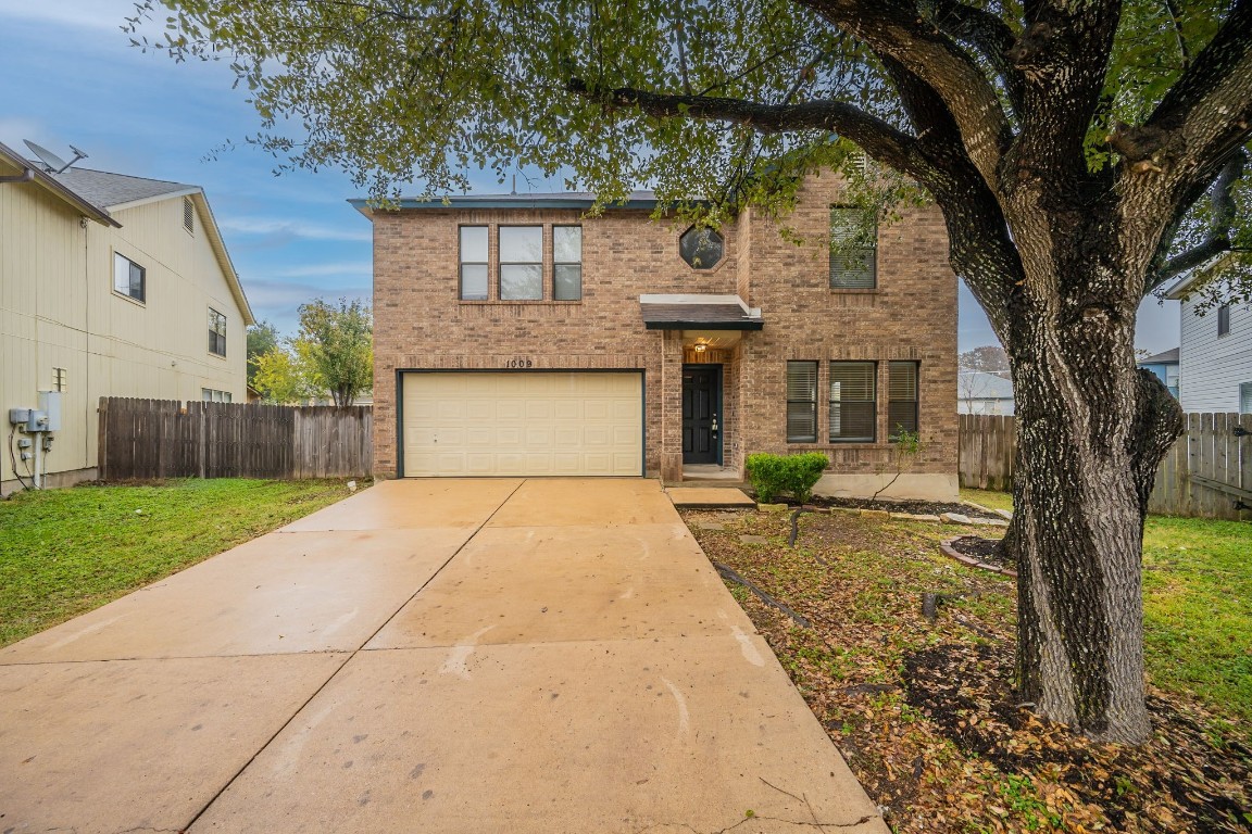 a front view of a house with a yard and garage