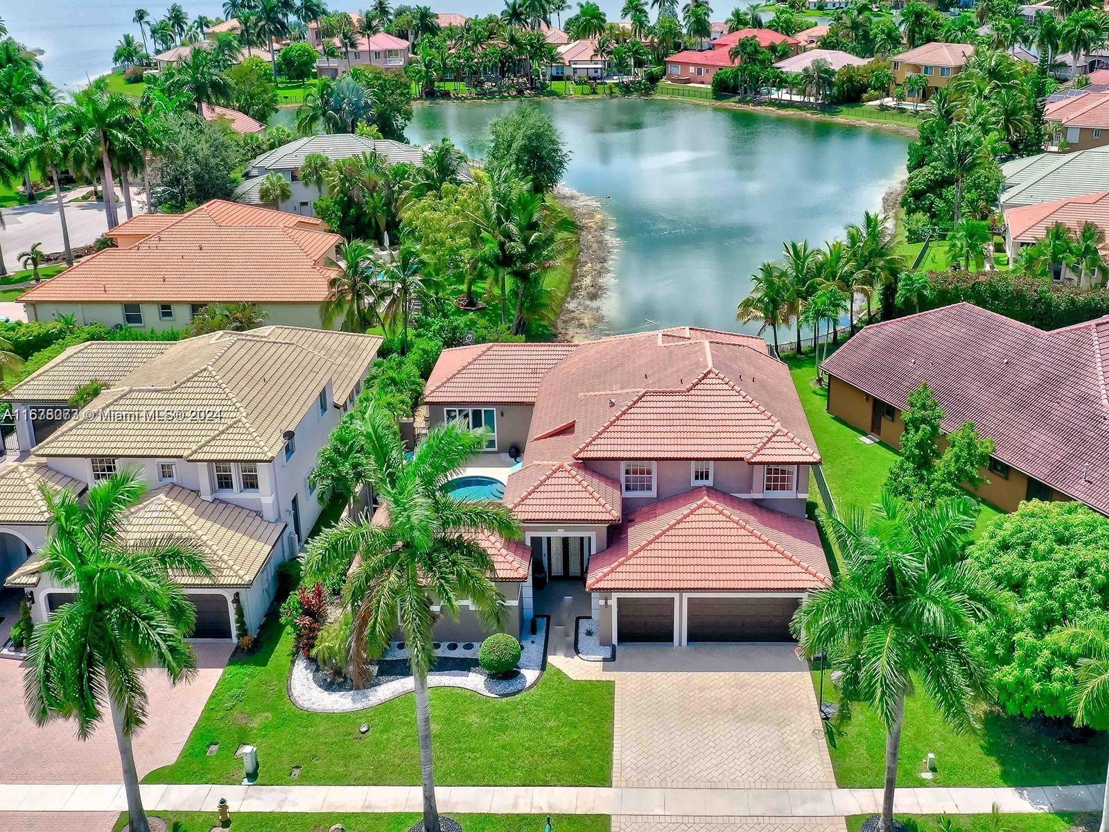 an aerial view of a house with garden space and lake view