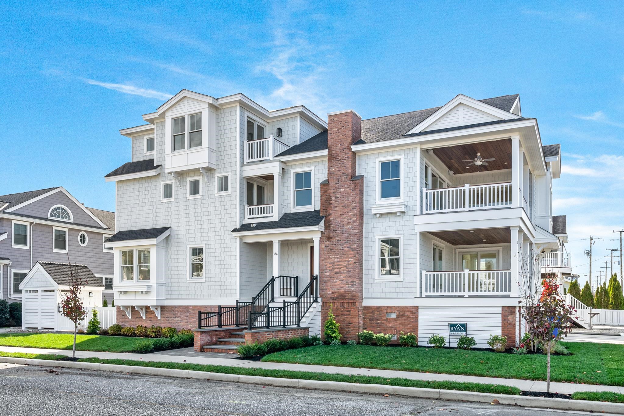 a front view of a residential apartment building with a yard