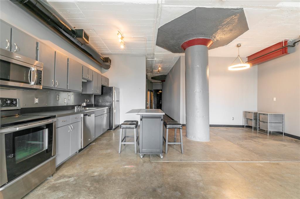 a kitchen with cabinets and chairs