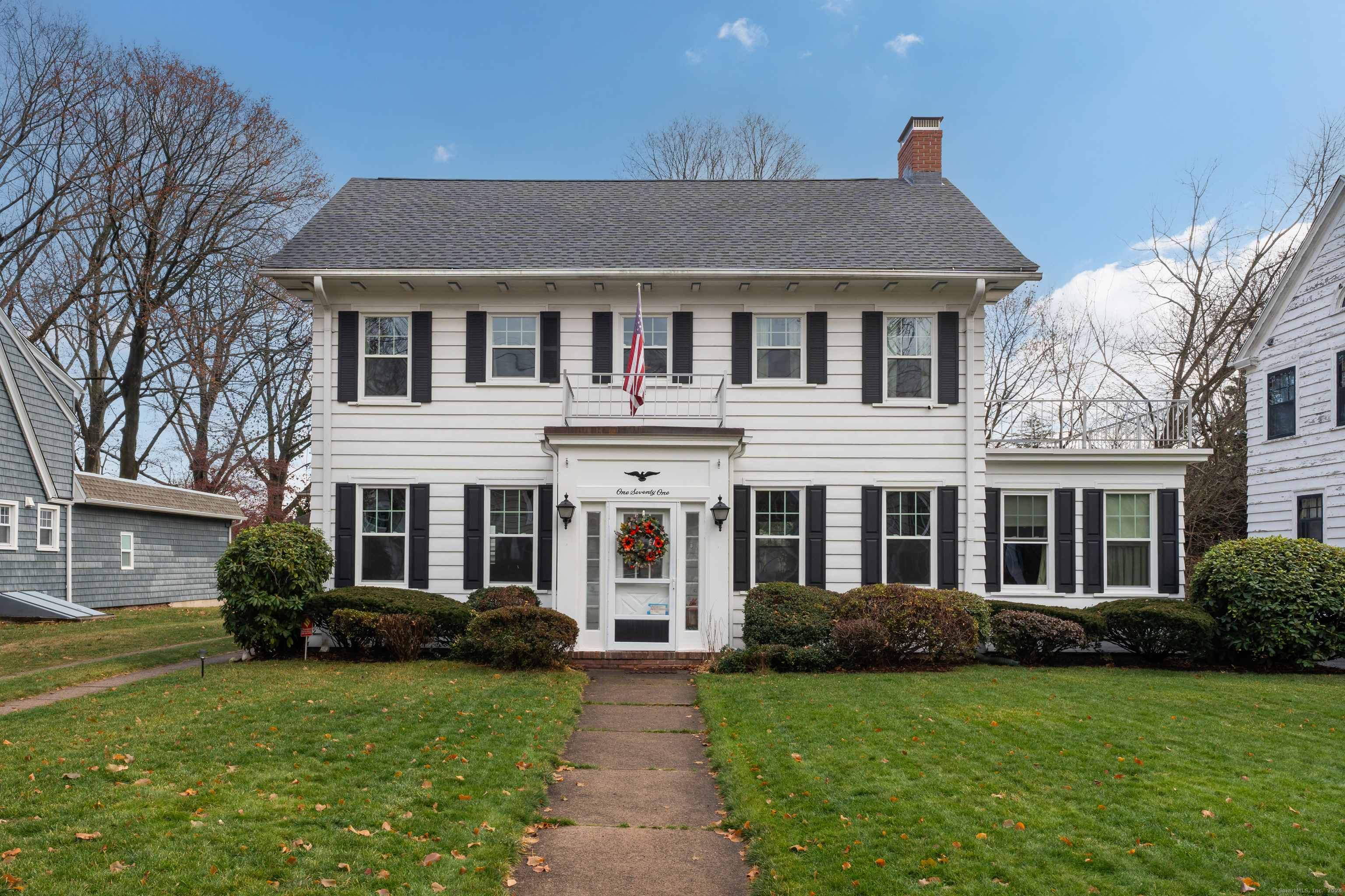 a front view of a house with garden and porch