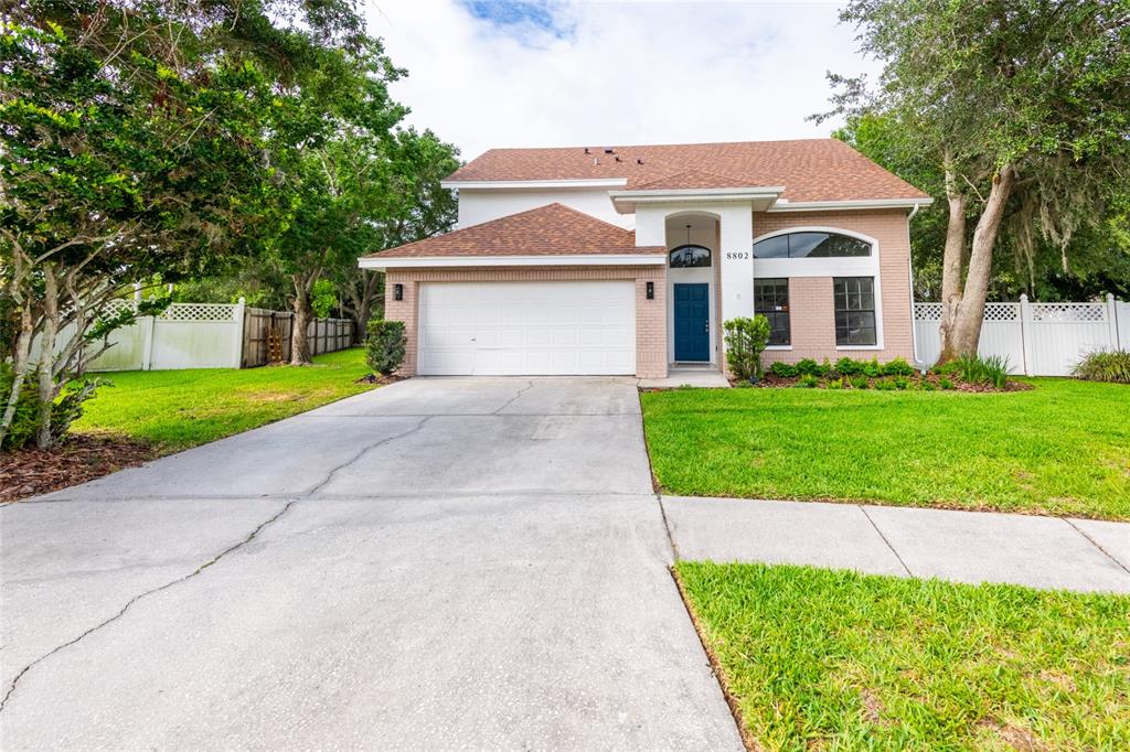 a front view of a house with a yard and garage