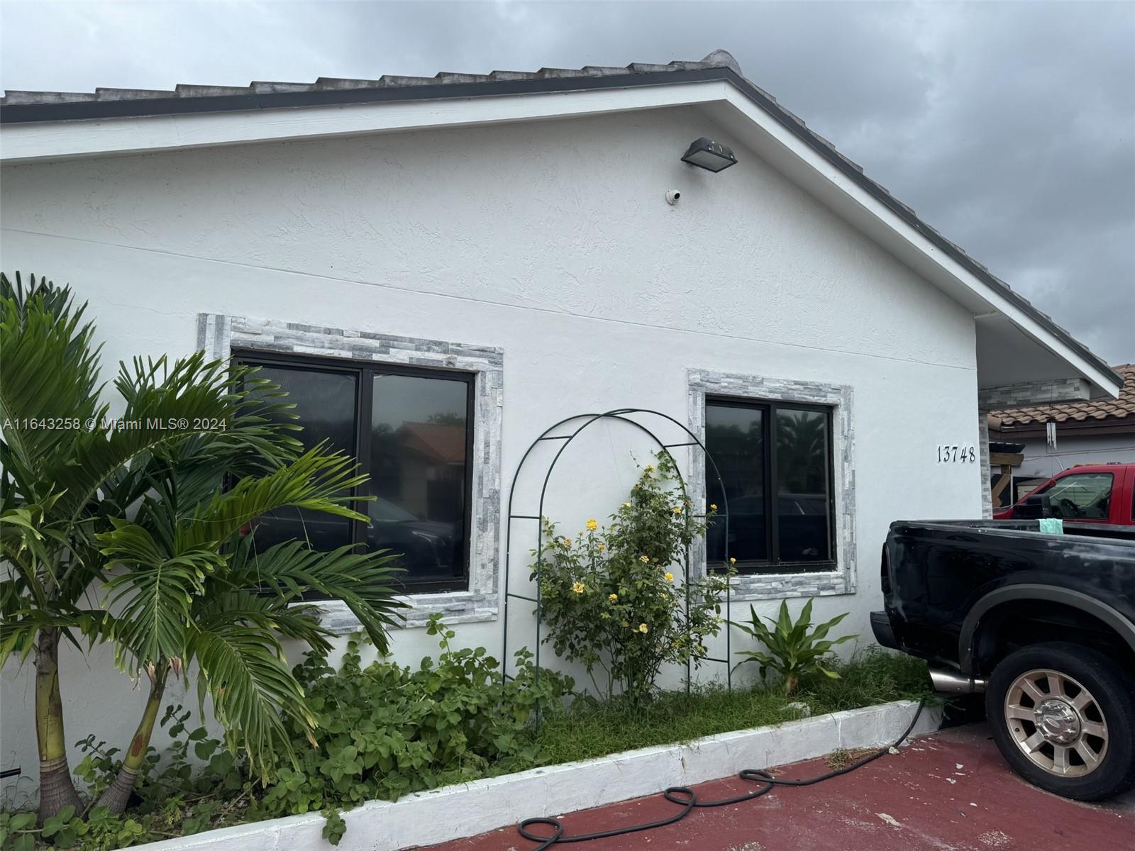 a front view of a house with garden