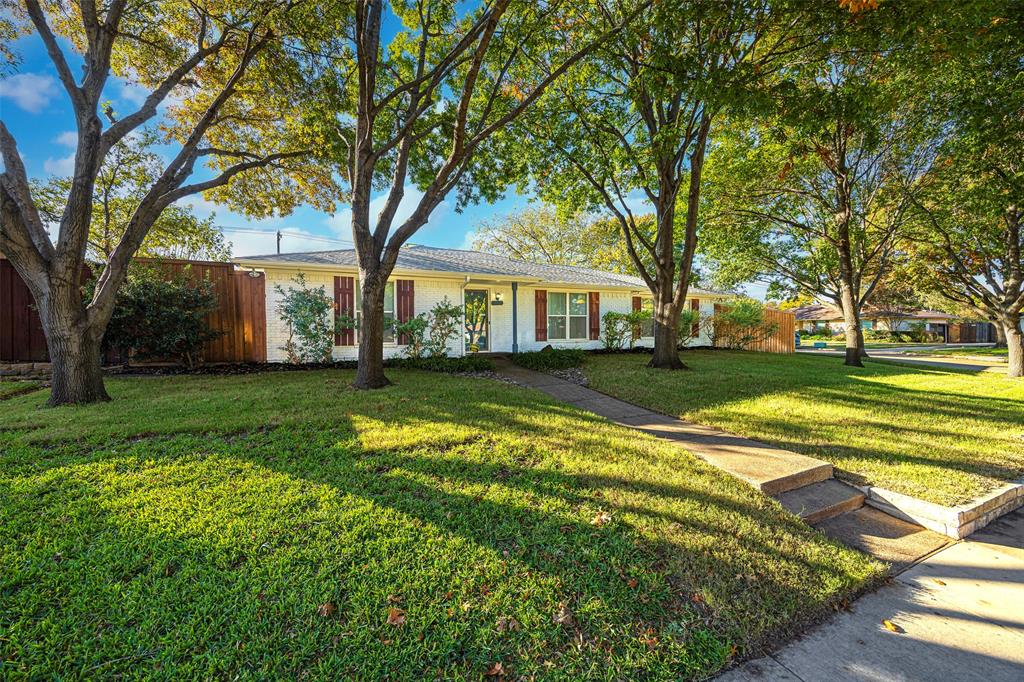 Single story home featuring a front lawn