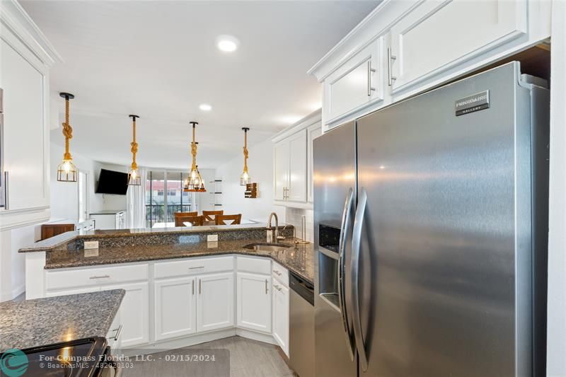 a kitchen with a sink and refrigerator