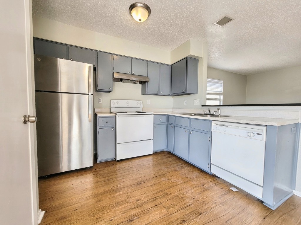 a kitchen with a sink stainless steel appliances and cabinets