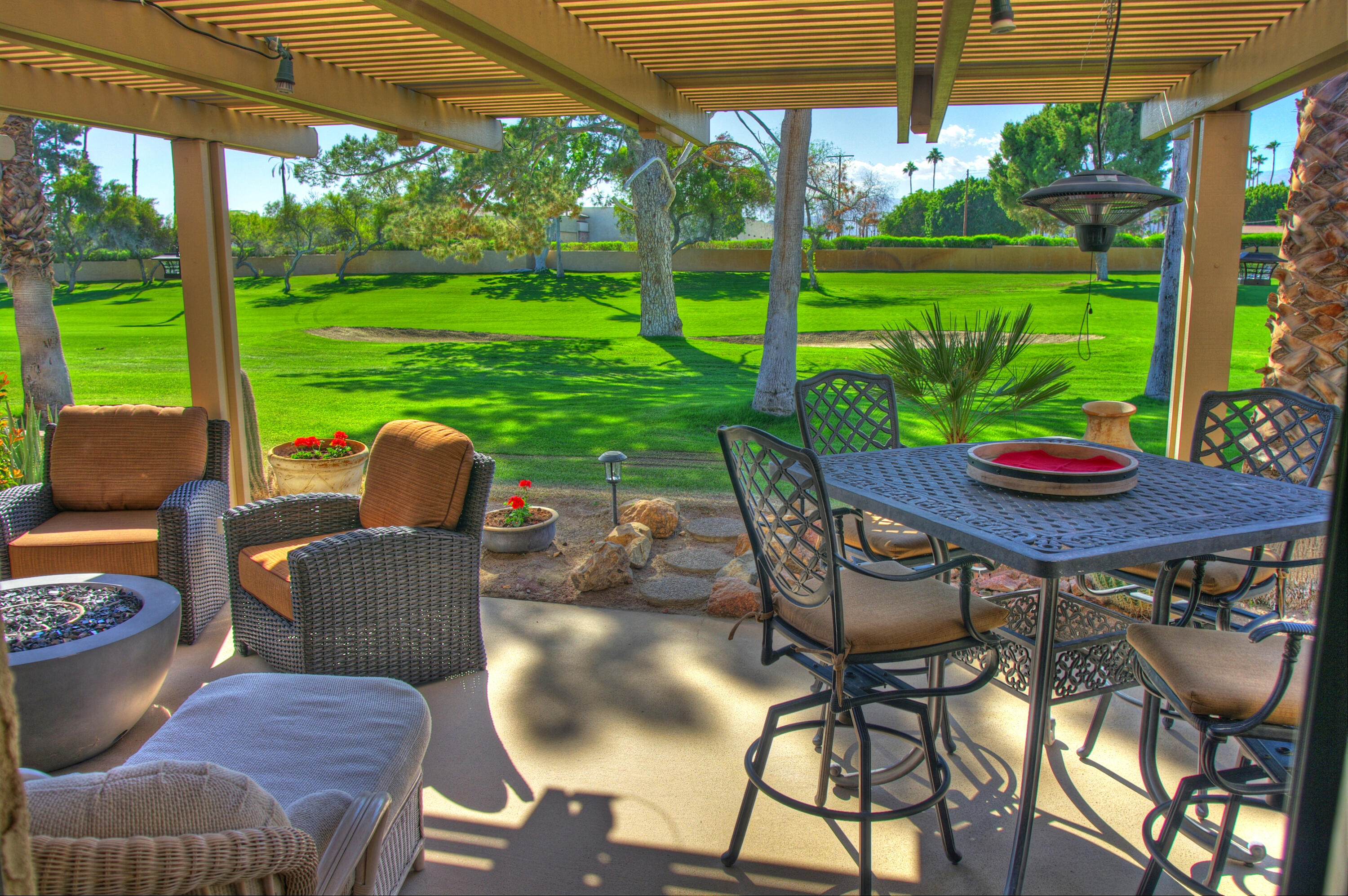 a view of a patio with a table chairs and a backyard