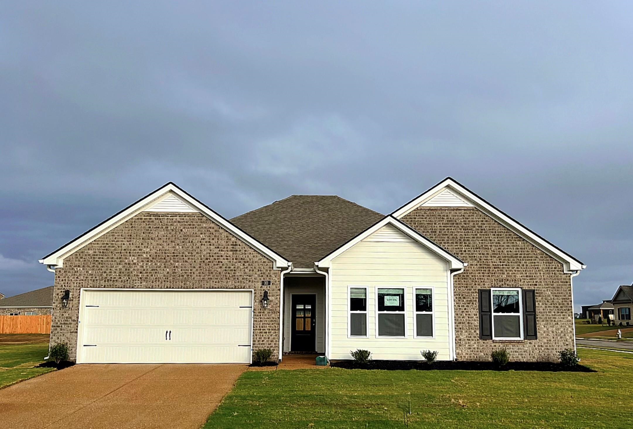 a view of a house with a yard and deck