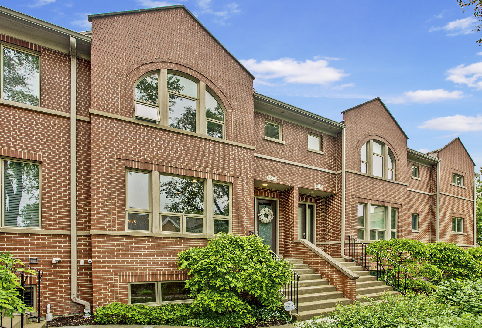 a view of a brick building next to a yard