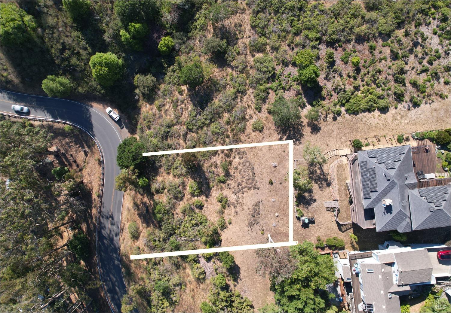 an aerial view of a house with a yard