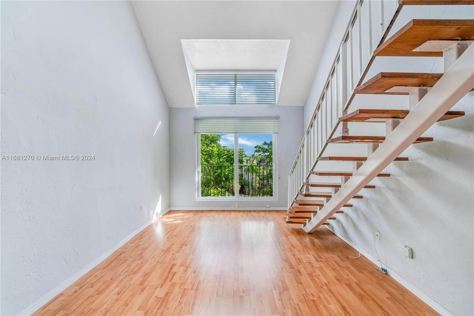 a view of entryway with wooden floor and stairs