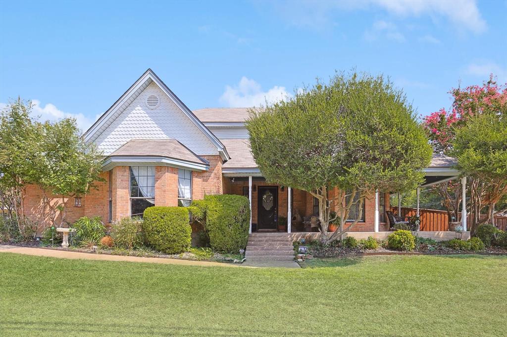 a front view of a house with a garden and plants