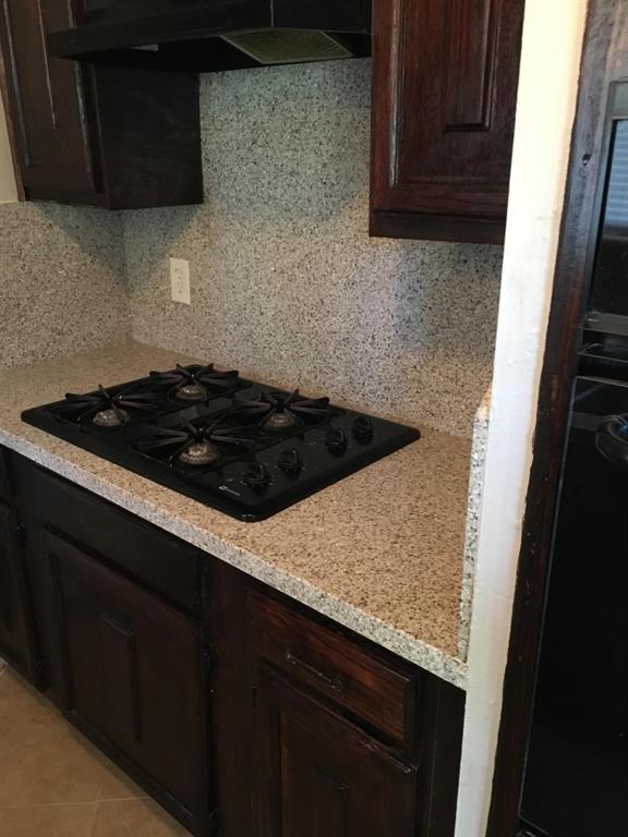 a kitchen with a sink a stove and cabinets