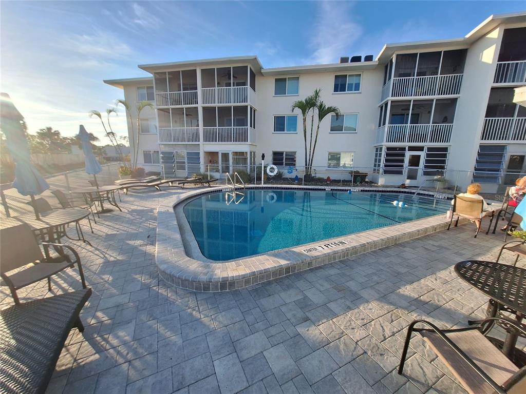 a view of a swimming pool with a lounge chairs