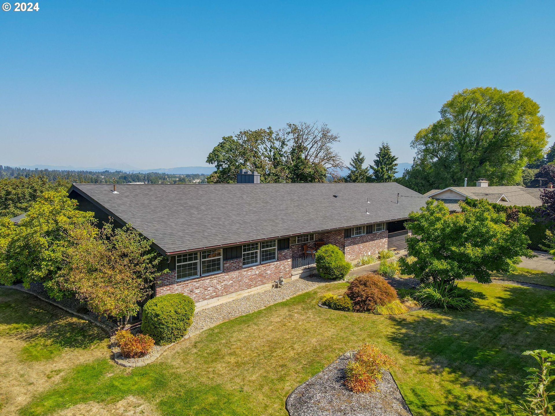 an aerial view of a house with a yard basket ball court and outdoor seating