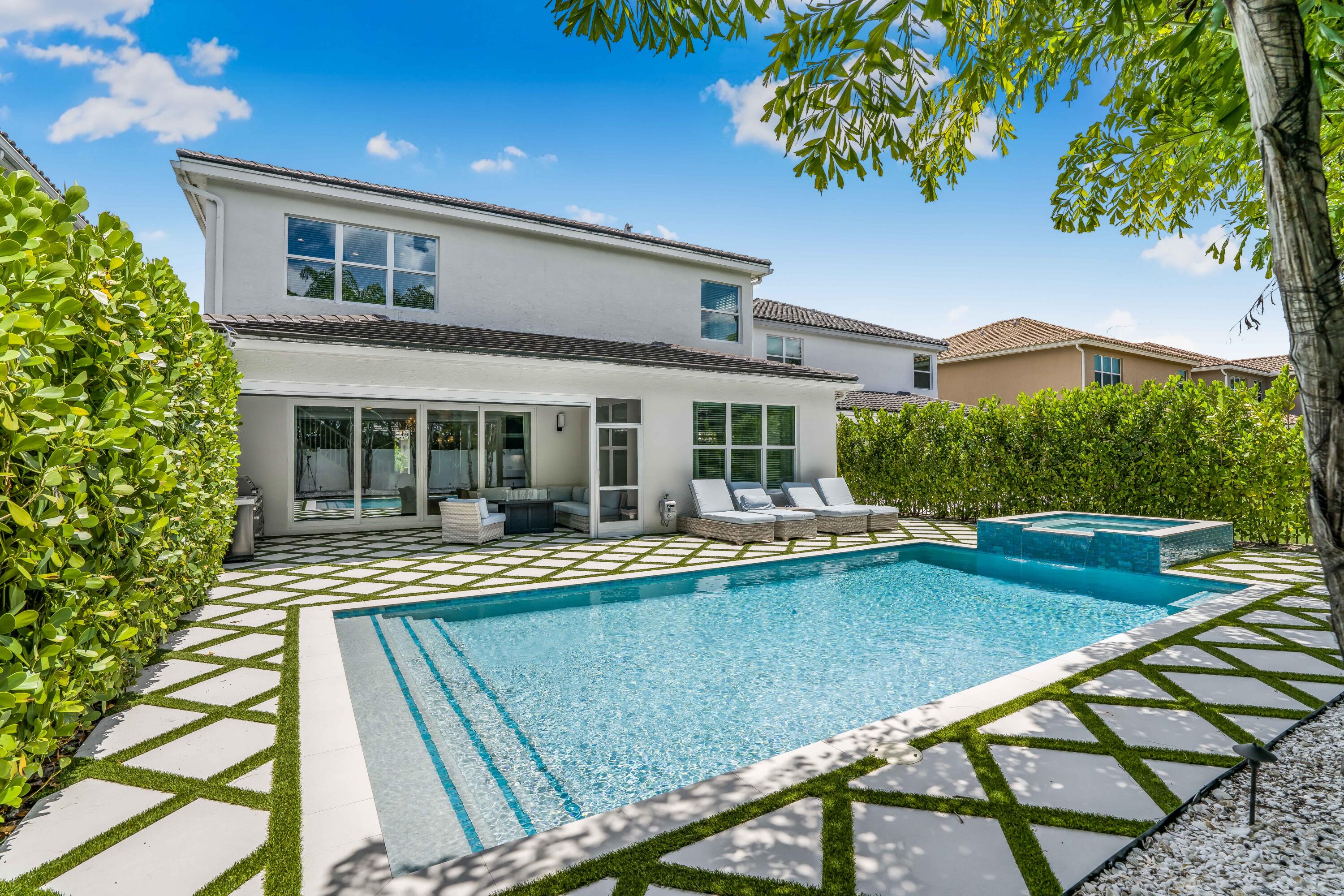 a view of a house with swimming pool and sitting area