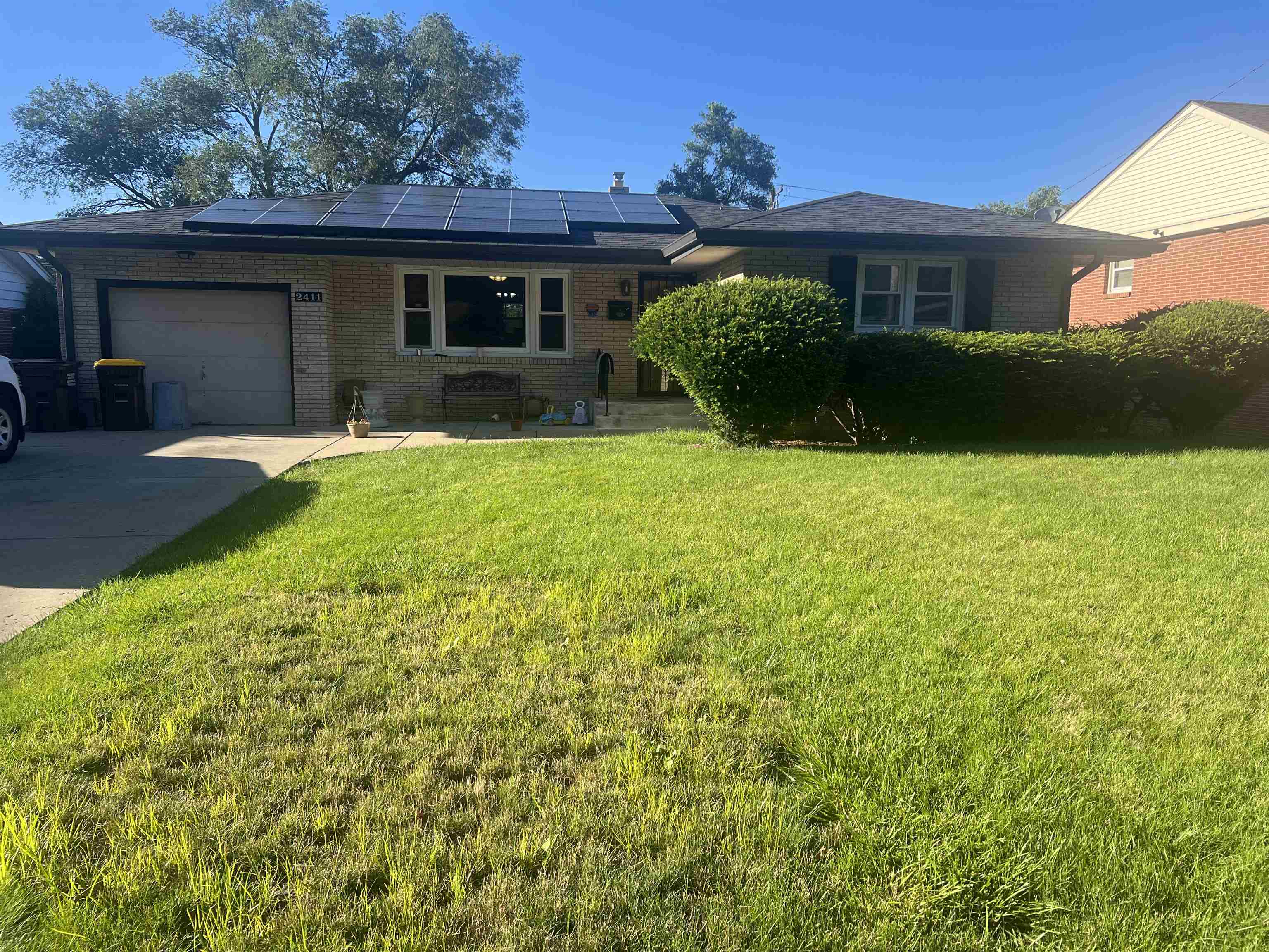 a view of a house with garden and yard