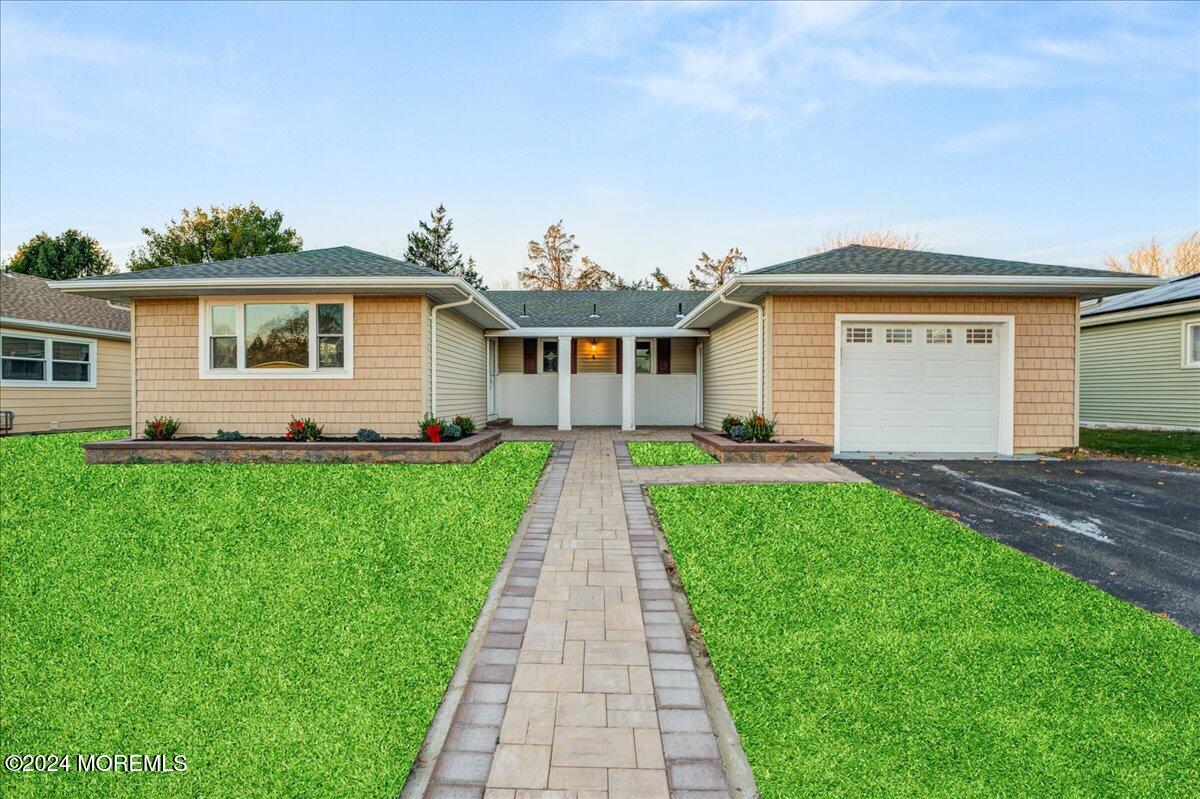 a front view of house with yard and green space