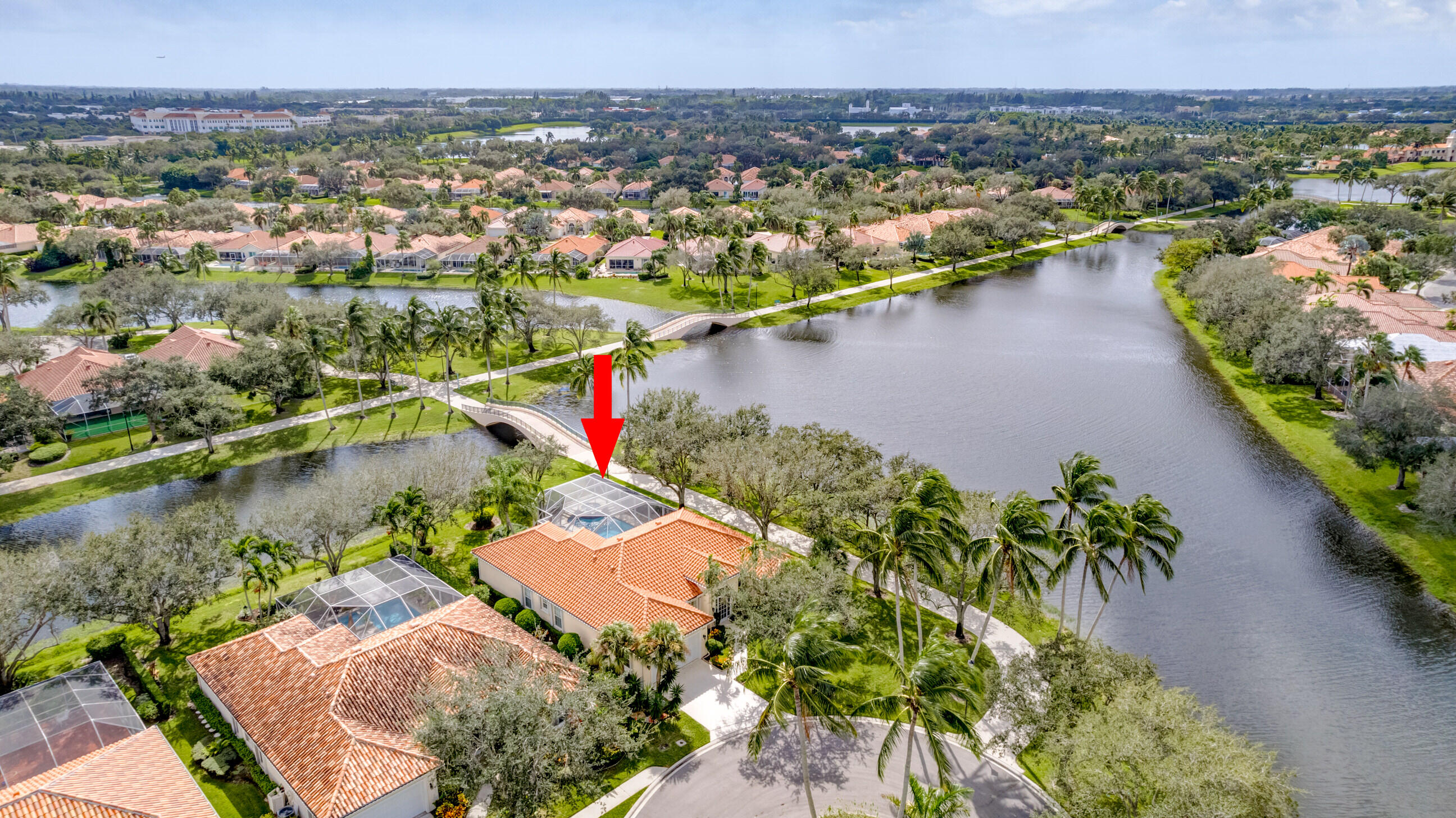 an aerial view of residential houses with outdoor space and lake view