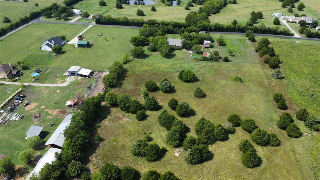 an aerial view of a residential houses with outdoor space