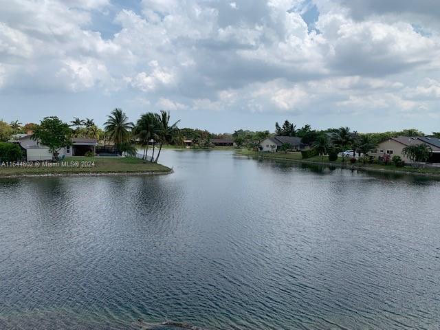 a view of a lake with houses in the back