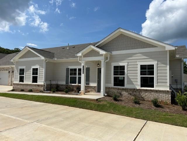 a front view of a house with yard and green space