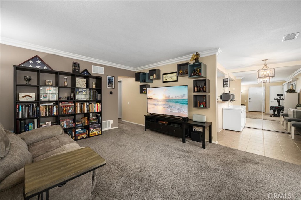 a living room with furniture a rug and gym equipment