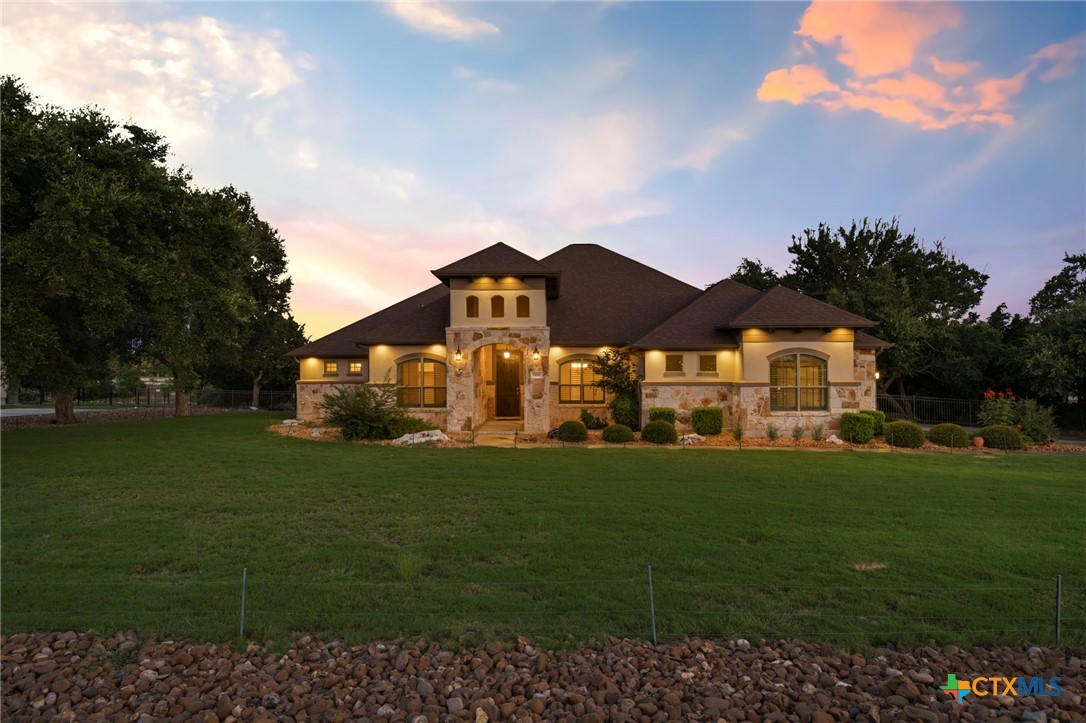 a front view of a house with garden