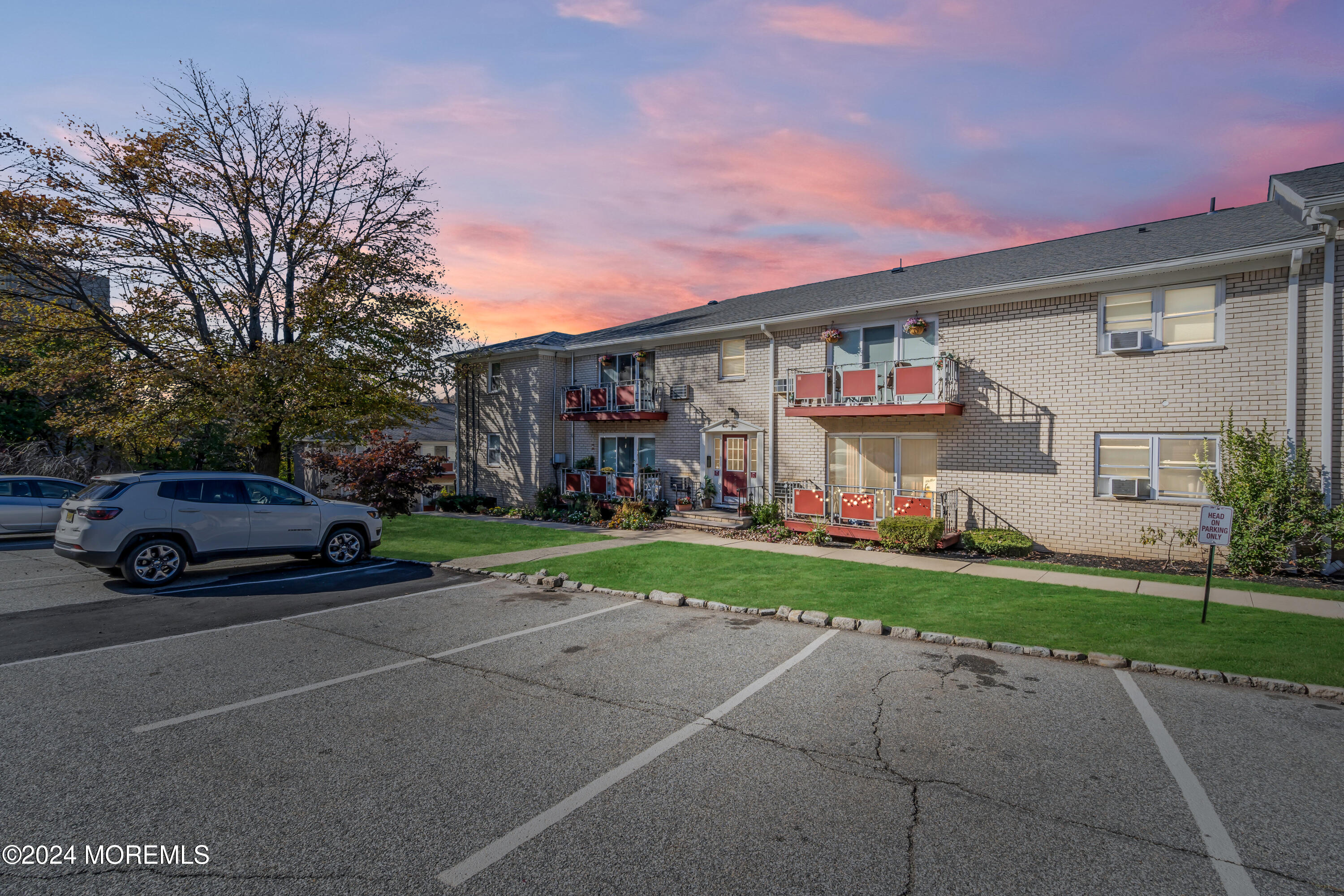 a view of a car park in front of a house