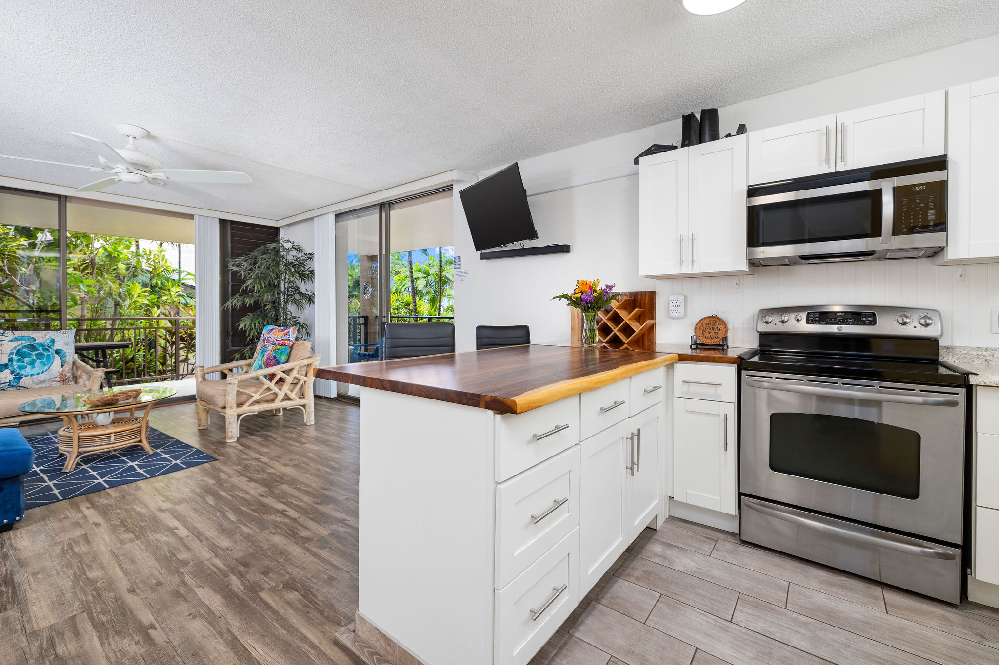 a kitchen with stainless steel appliances white cabinets a sink and a stove