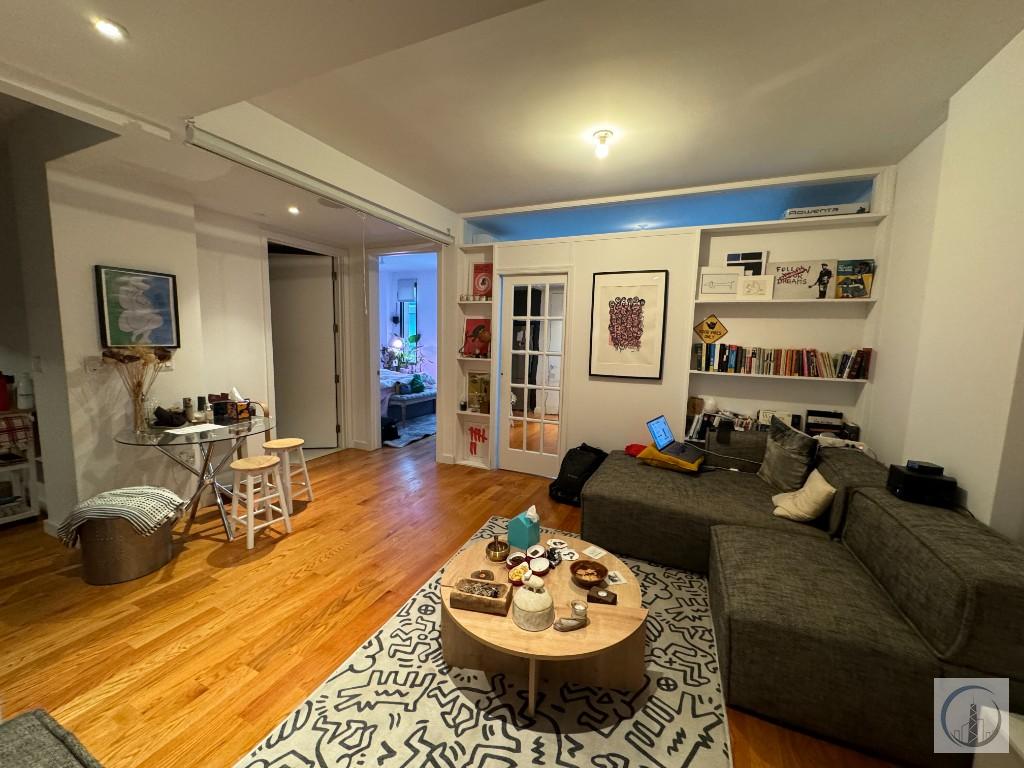 a living room with furniture and view of kitchen