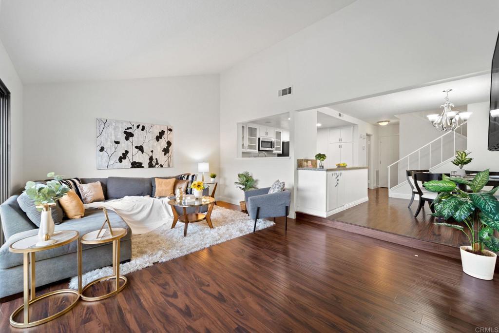 a living room with furniture and a kitchen view