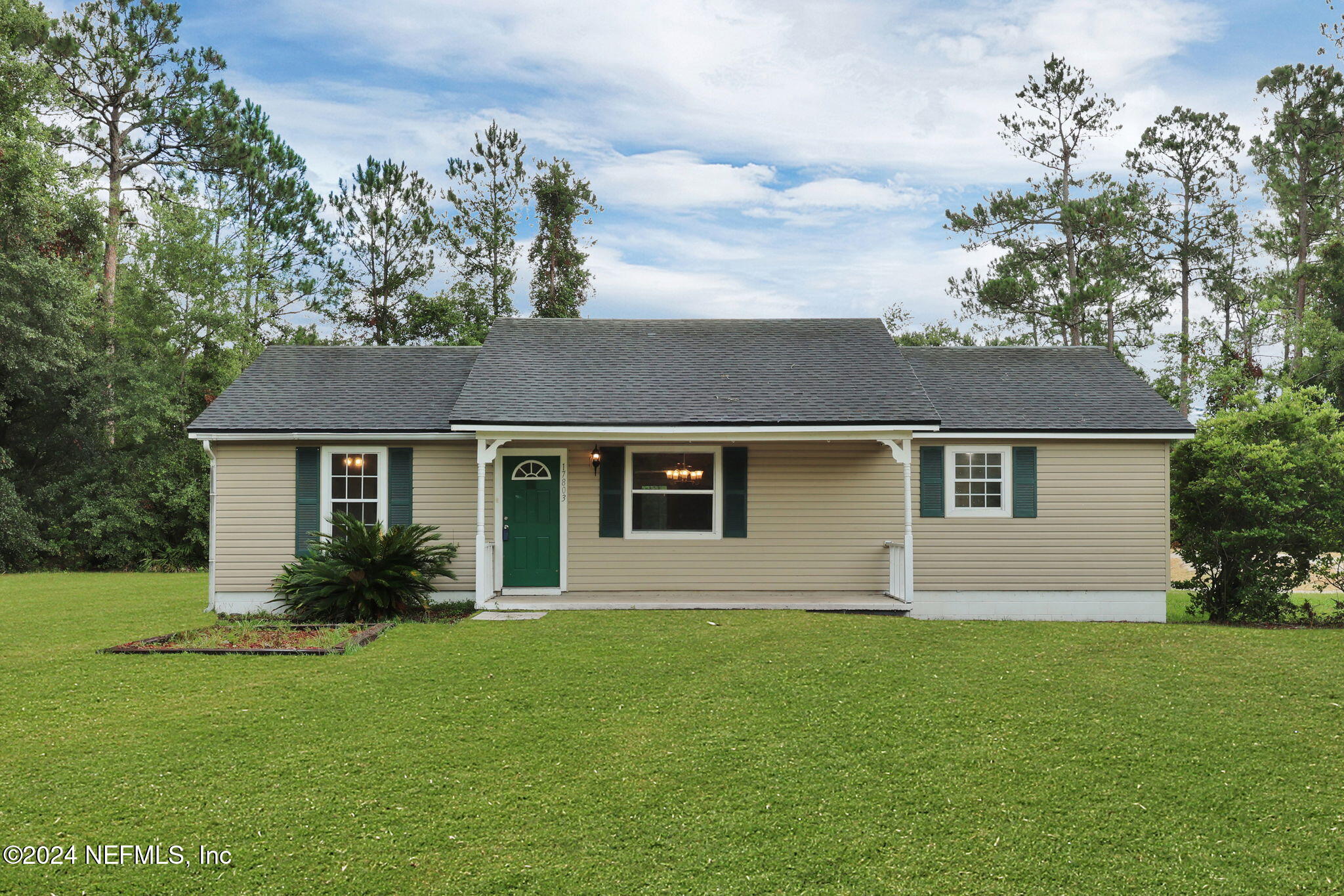 a front view of house with yard and green space