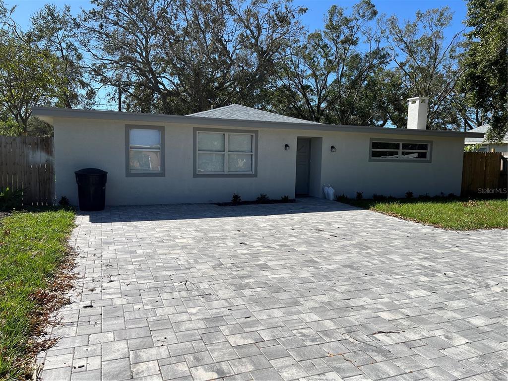 a front view of a house with a yard and a garage