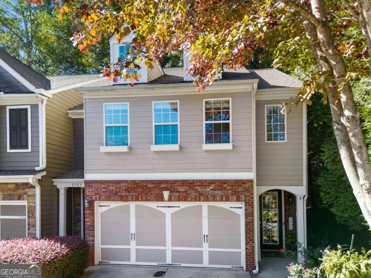 a front view of a house with a yard