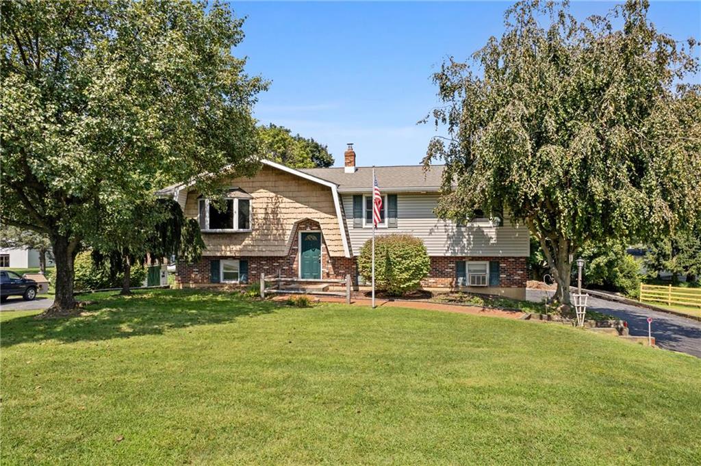 a front view of a house with patio and yard